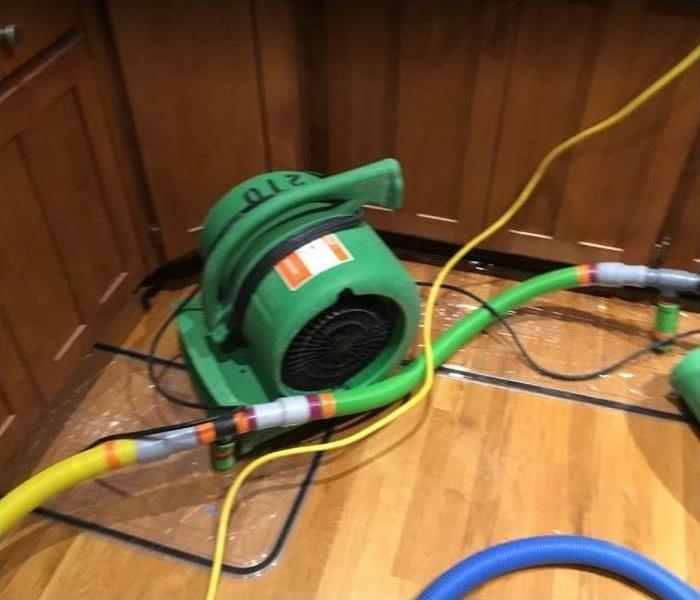 SERVPRO restoration equipment being used in water damaged kitchen / dining room