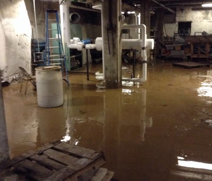basement with a concrete floor covered in water